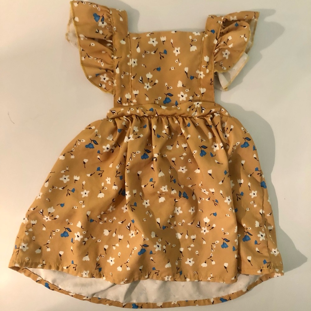 Adorable Fall dress with straps around the shoulders to the back.